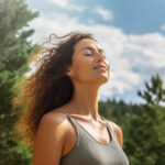 Relaxed woman breathing fresh air in a green forest