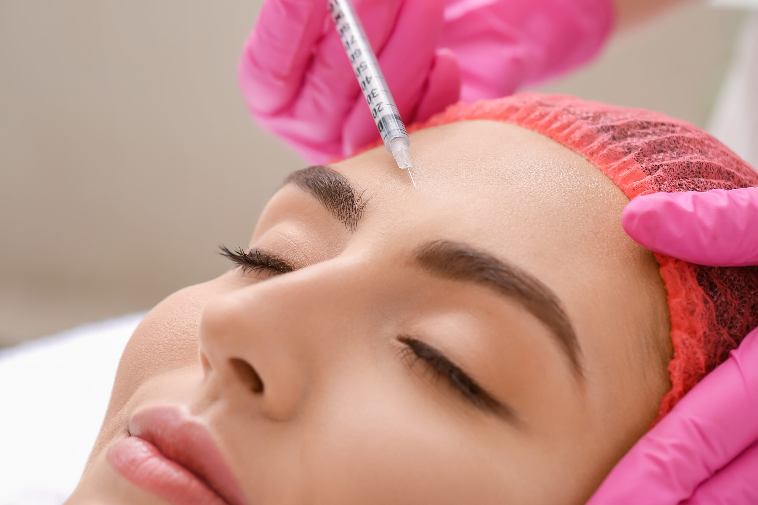 Young woman undergoing treatment in beauty salon, closeup